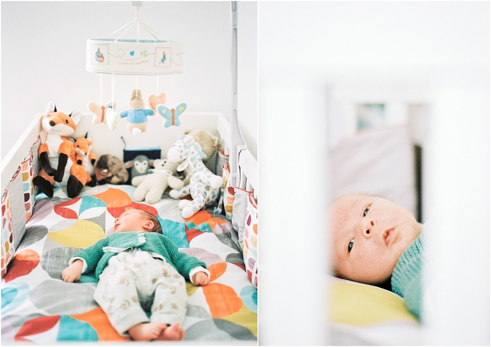 Baby in nursery surrounded by toys, Herts