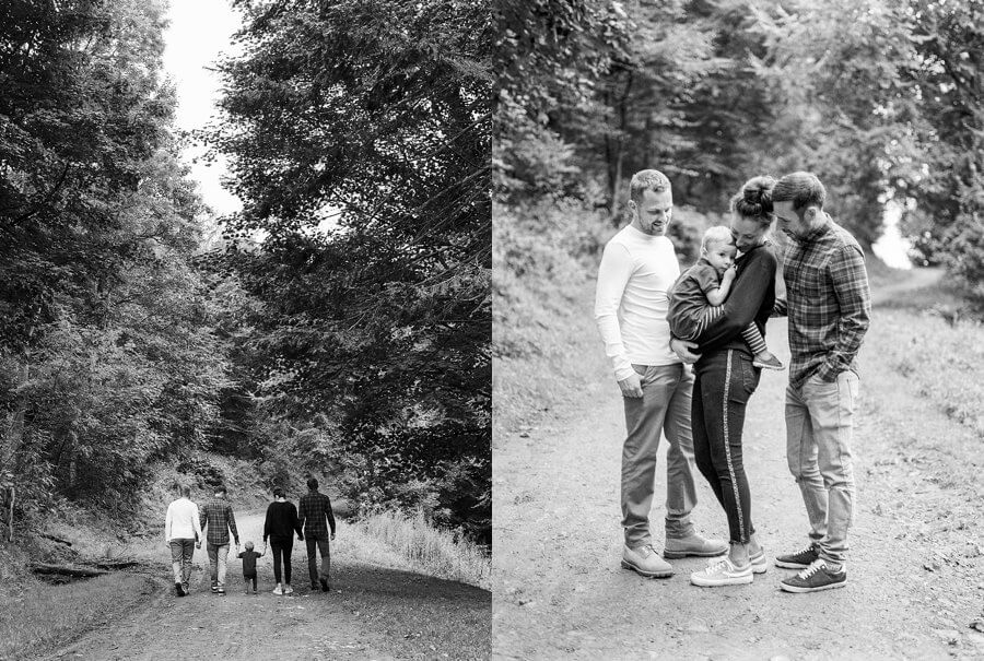 Black and White portaits of family walking into the woods in the distance and cuddling child in a group | Family Woodland Shoot